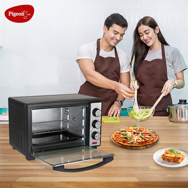 A man and Girl cooking food by using Pigeon 20L Electric Oven OTG with Grill & Rotisserie - Perfect for Grilling & Baking Cakes (Grey) by Bijli ki dukan